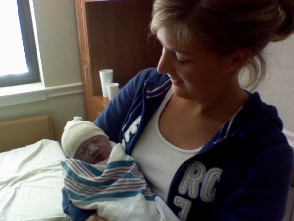 A woman holding a baby in the hospital
