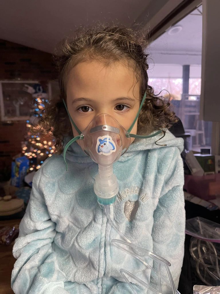 Little girl having a breathing treatment