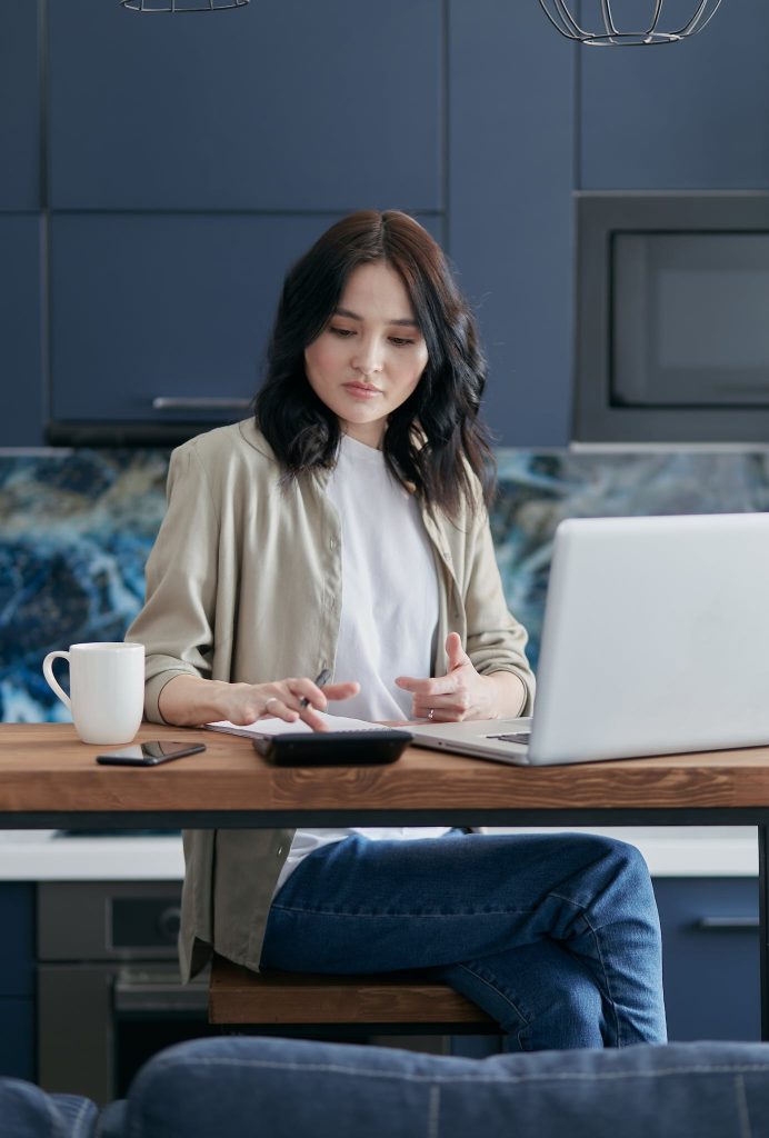 A Woman Sitting on a Chair while Working