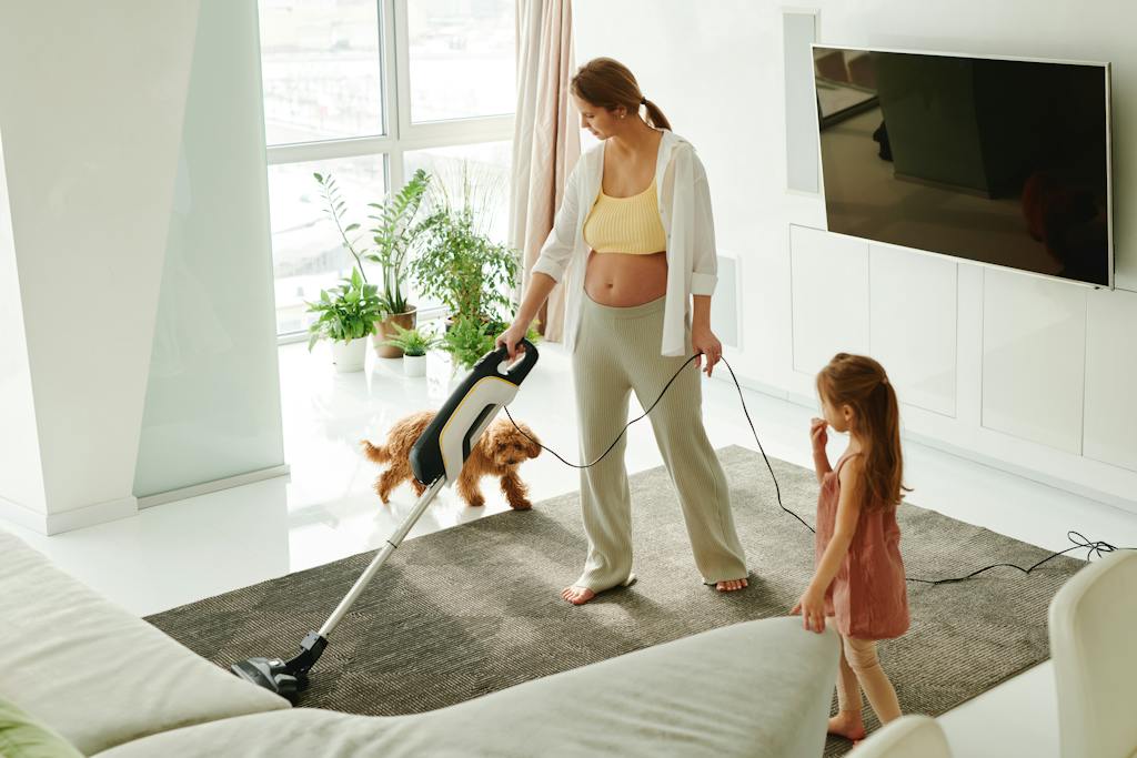 A Stay at home mom using a Vacuum